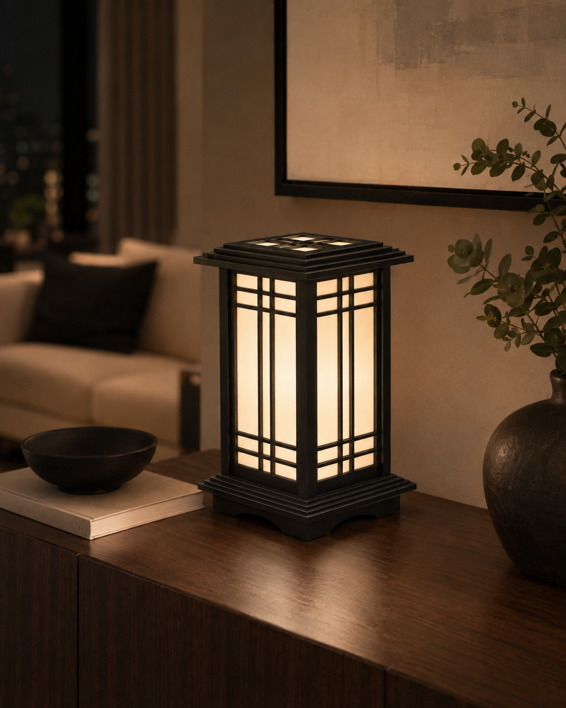 Rich Ebony Kyoto Shoji lamp casting warm light beside books and a vase