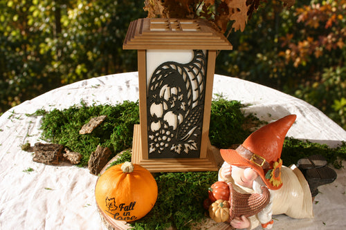 Kyoto lamp with Autumn Cornucopia panel displayed beside a pumpkin and gnome