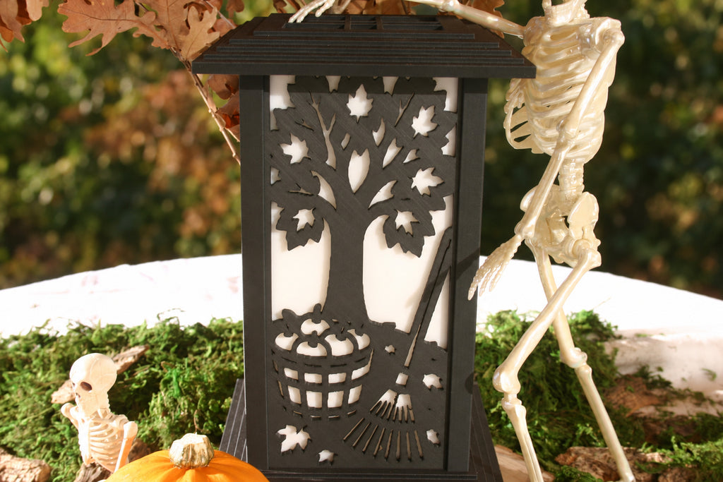 Harvest Tree panel on a Kyoto lamp showing a tree, falling leaves, pumpkins and a rake