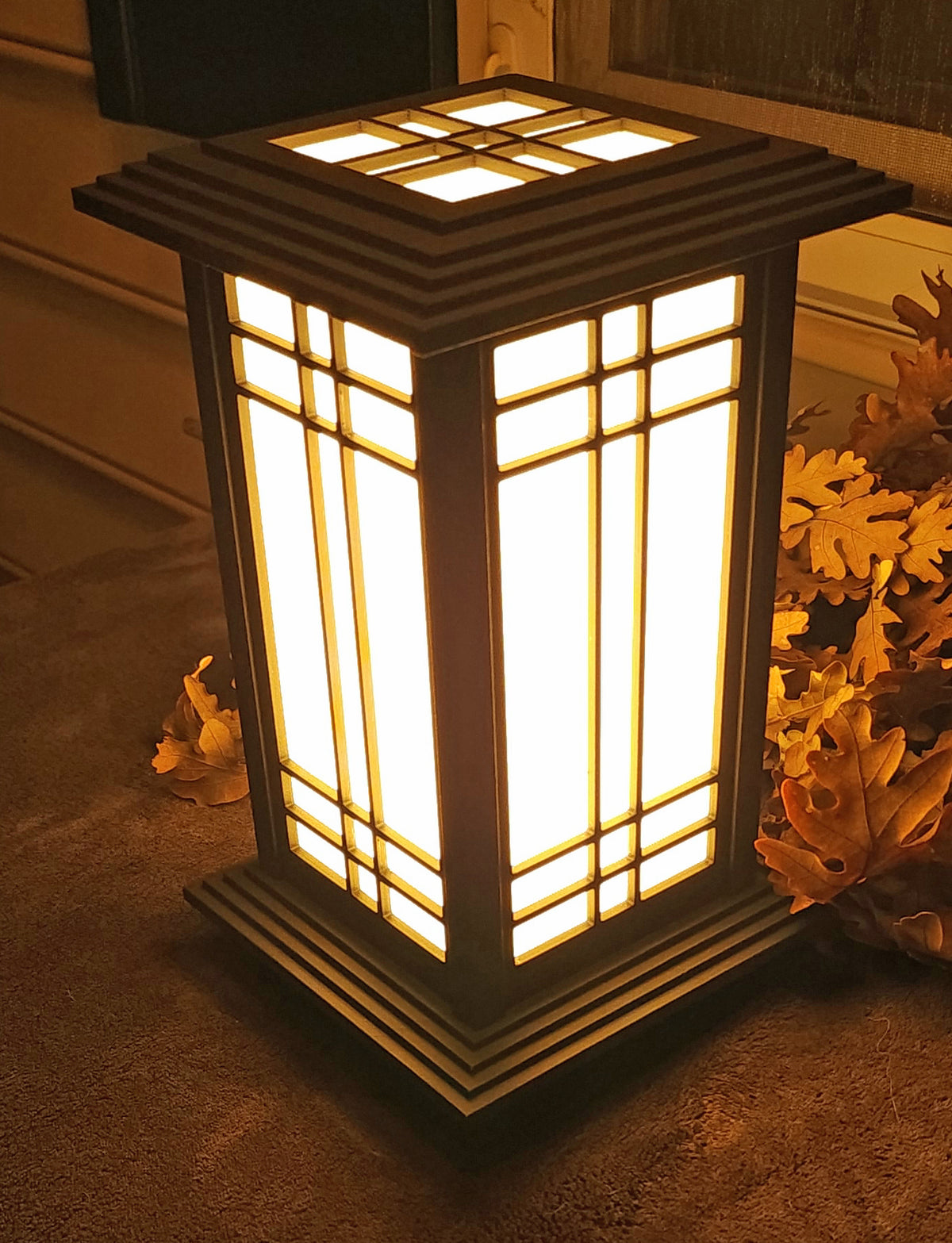 Illuminated Rich Ebony Kyoto Shoji lamp viewed from above to show the roof and frame
