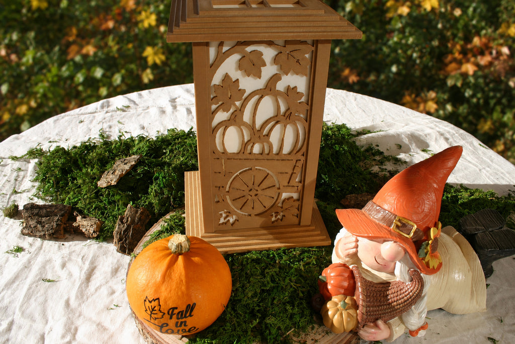 Kyoto lamp with Pumpkin Wagon panel beside a pumpkin and gnome on a moss-covered display
