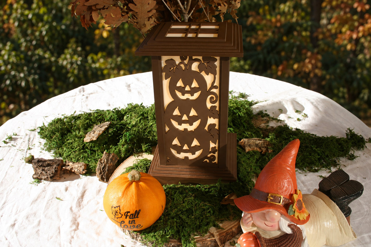Kyoto lamp with Stacked Jack-o'-Lanterns panel displayed among moss, a pumpkin and a gnome