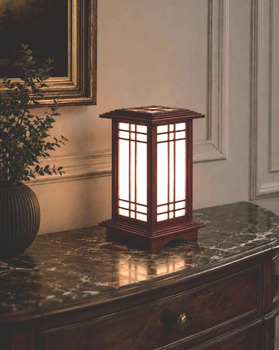 The Prairie Beacon table lantern pairs an inviting wood-tone finish with the sculptural elegance of American-inspired architecture. Slender corner posts, intricate geometric latticework, and translucent panels rise from a square base to a gracefully overhanging roof. Thoughtfully designed and 3D printed, its layered details create a distinctive statement piece, bringing warmth, character, and architectural beauty to a bedside table, bookshelf, or favorite corner.